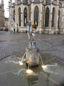 Missing half it's head... Pouring beverage into said head, while reading a book.  Creepy fountain.